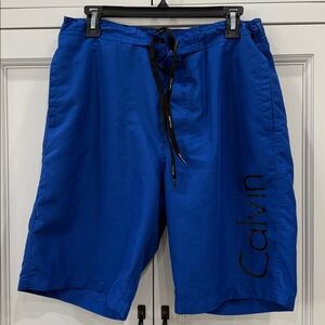 Calvin Klein Mens Size Medium Solid Logo Swim Trunks. Royal Blue with black
